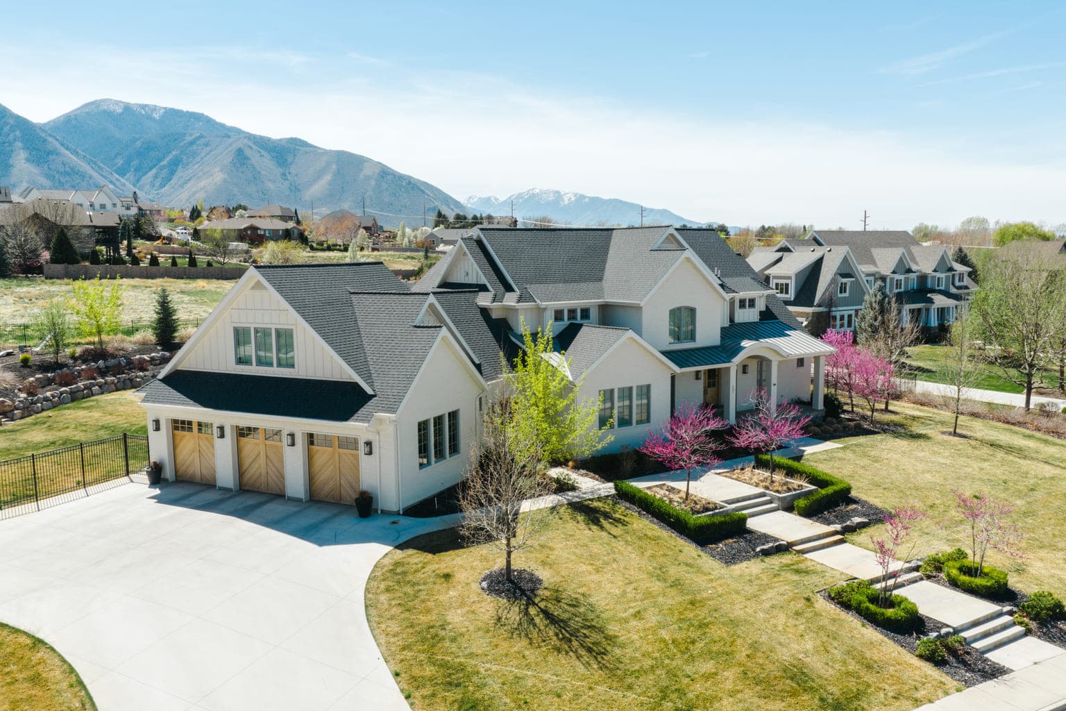 Luxury property exterior with mountain backdrop — drone real estate photography, Montana